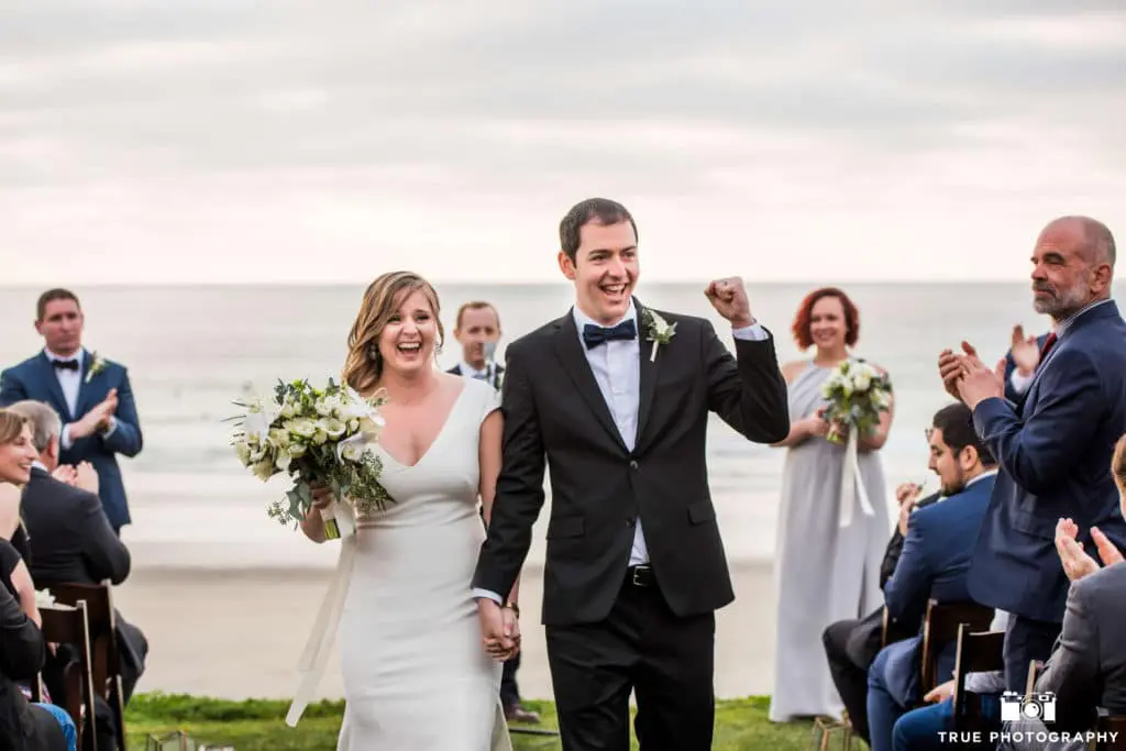 After the Big Kiss, the happy couple makes their way back down the aisle, positively glowing with happiness.