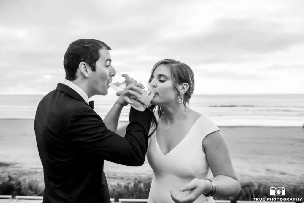 Locking arms, the newlyweds take a sip of their signature cocktails.