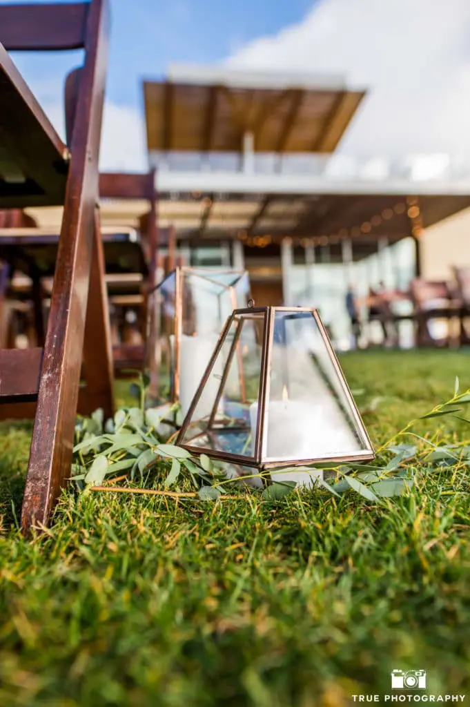 Beachy details, like these lanterns, helped line the aisle and welcomed guests to their seats.