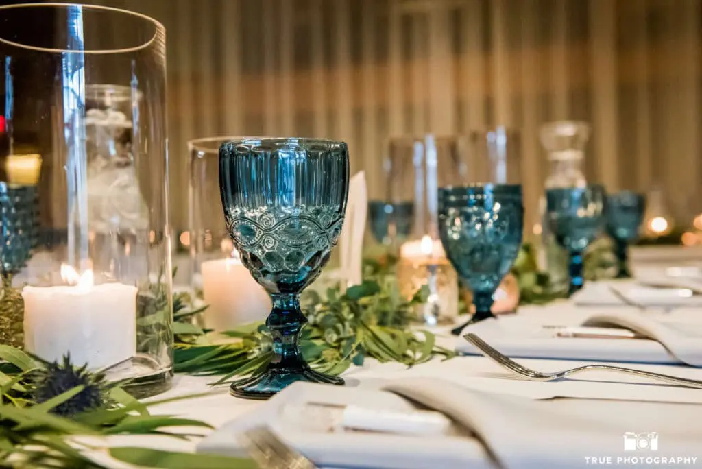 Blue water goblets like these bring the beach indoors and elevate the look of a place setting.