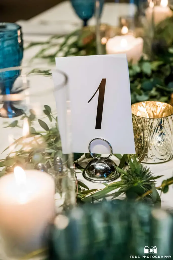 Simple table numbers complimented the elegant table centerpieces.