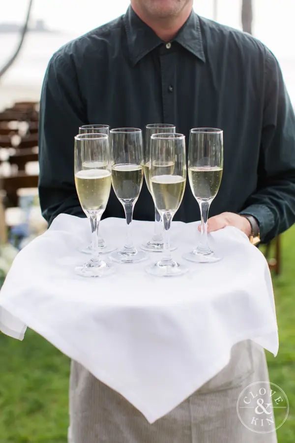 A server hold a tray of champagne during cocktail hour.