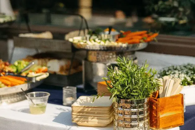 Fresh vegetable display with dips and artisan bread at a buffet table, holiday party catering by Personal Touch Dining.
