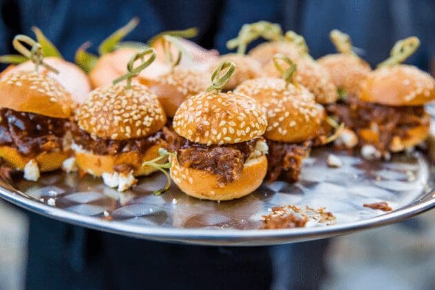 Mini beef sliders with caramelized onions and truffle aioli, a popular catering snack for office parties and corporate events