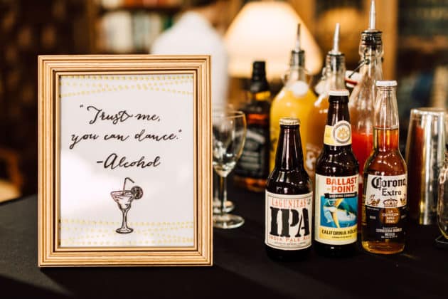Wedding bar with Lagunitas IPA, Ballast Point Kolsch, and Corona beside a framed 'Trust me, you can dance' sign