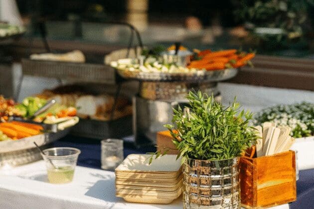 Fresh vegetable display with dips and artisan bread at a buffet table, holiday party catering by Personal Touch Dining.
