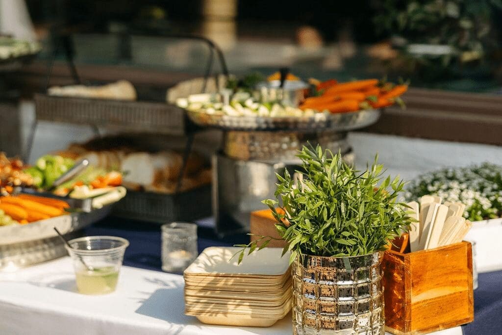 Fresh vegetable display with dips and artisan bread at a buffet table, holiday party catering by Personal Touch Dining.