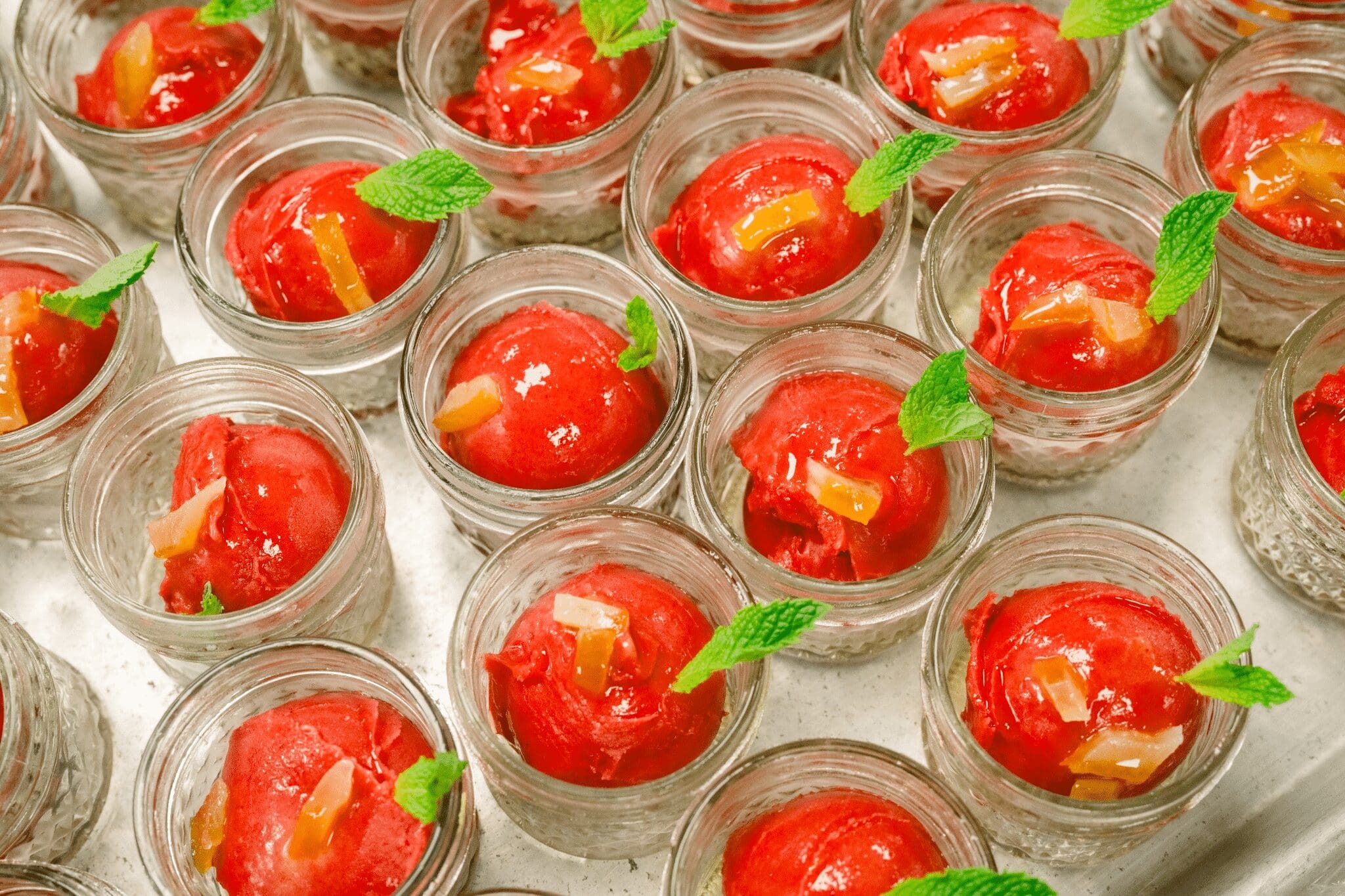 Mini jars of raspberry sorbet with mint, a light finish for an autumn menu.